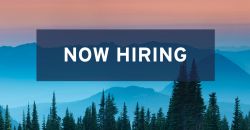 Now Hiring sign in front of mountains